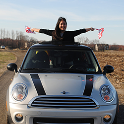Lucero riding in Mini Cooper with Flags